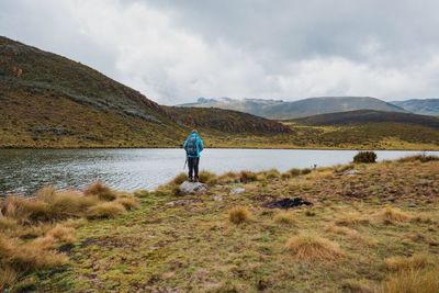 Rear view of backpacker against a mountain background at lake ellis, chogoria route, mount kenya