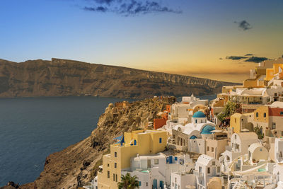 High angle view of town by sea against sky