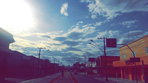 Buildings in city against cloudy sky