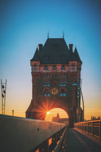 Low angle view of illuminated bridge against sky during sunset