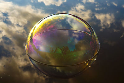 Close-up of bubbles in water against sky