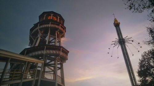 Low angle view of amusement park ride against sky