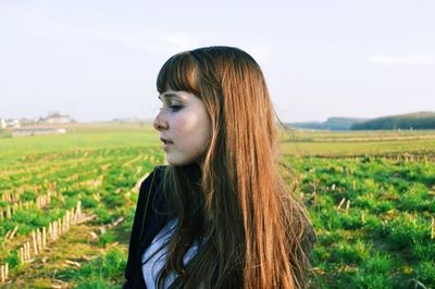 Woman standing on grassy field