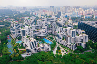 High angle view of modern buildings in city against sky