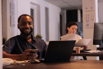 Portrait of smiling business colleagues working in office