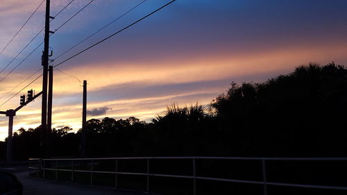 Silhouette of trees against dramatic sky