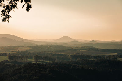 Scenic view of landscape against clear sky during sunset