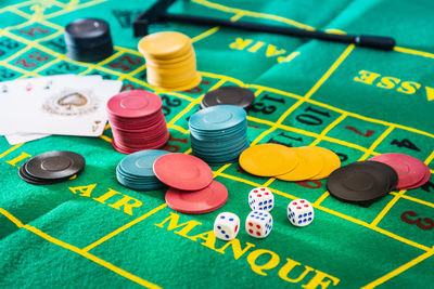 Playing cards with gambling chips on table