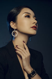 Portrait of a young woman against gray background