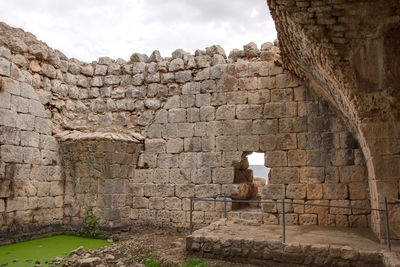 View of stone wall against cloudy sky