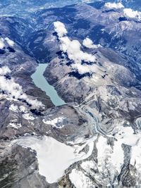 Aerial view of snowcapped mountains against sky