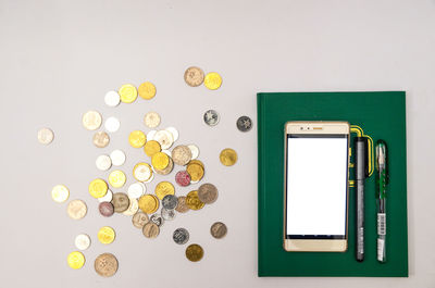 Directly above shot of coins on table against wall