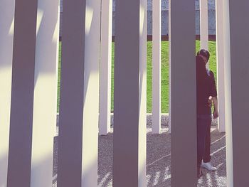 Man standing by palm tree