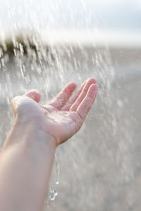 Cropped hand of person in water