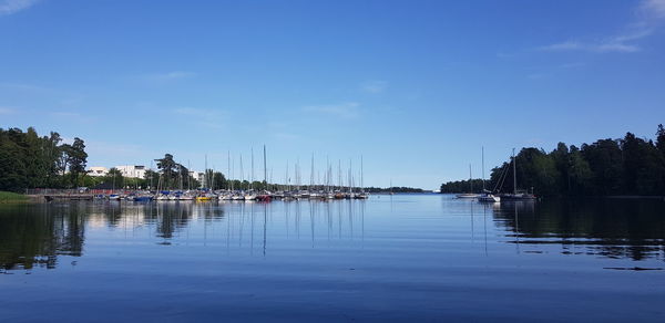 Sailboats in lake against sky