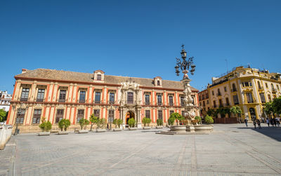 Low angle view of historic building against clear blue sky