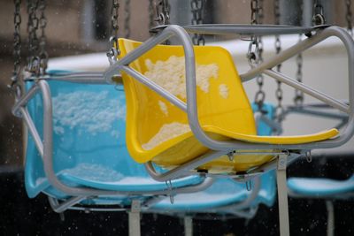 Close-up of snow on chain swing ride