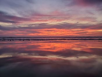 Scenic view of sea against orange sky