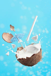Close-up of ice cream cone against blue sky