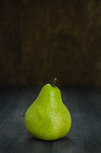 Close-up of green fruit on table