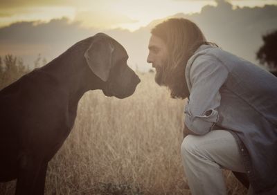 View of man and dog in field