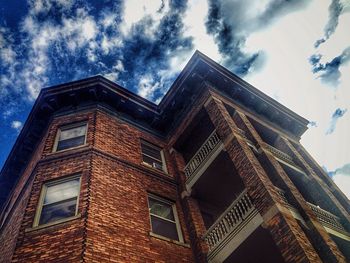 Low angle view of building against cloudy sky