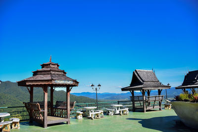 Gazebo by building against clear blue sky