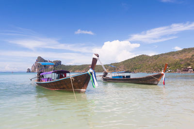 Nautical vessel moored on sea against sky