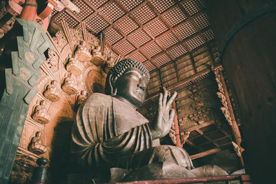 Low angle view of statue against building