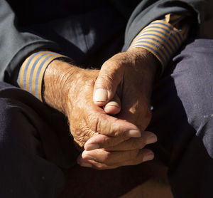 Close-up of man sitting on floor