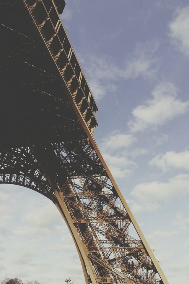 built structure, architecture, low angle view, connection, sky, bridge - man made structure, engineering, metal, cloud - sky, famous place, metallic, international landmark, eiffel tower, travel destinations, cloudy, tourism, travel, cloud, capital cities, transportation