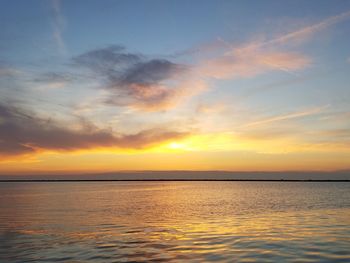 Scenic view of sea against romantic sky at sunset