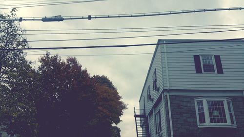 Low angle view of power lines against sky