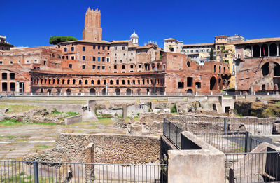 View of old buildings against blue sky