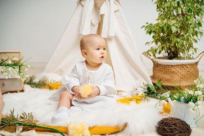 Portrait of cute girl playing with christmas tree