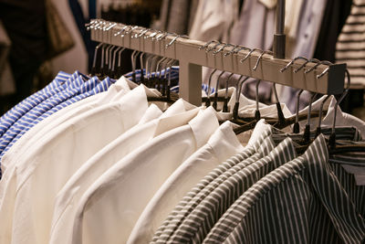 Hangers with men's clothing close-up in store