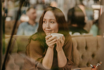 Portrait of a young woman drinking water