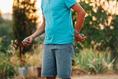 Close-up of man playing petanque