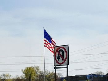 Information sign on road against sky