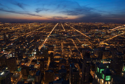 Aerial view of illuminated cityscape at night