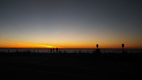 Scenic view of sea against clear sky at sunset