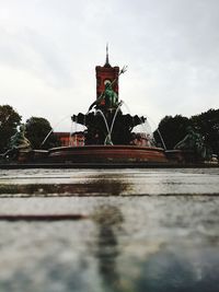 View of sculpture by building against sky