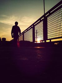 Silhouette of bridge against sunset sky