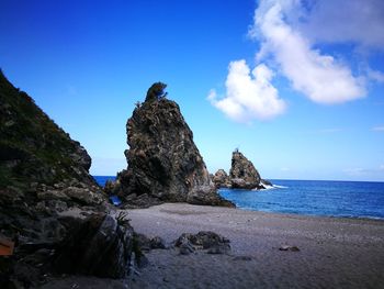 Scenic view of beach against blue sky