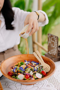 Midsection of woman preparing food on table