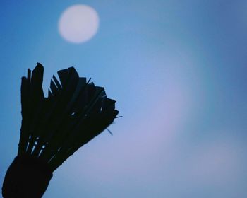 Low angle view of hand against clear blue sky