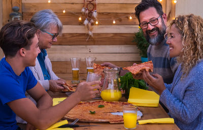 Happy people at table in restaurant