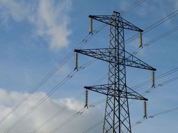 Low angle view of electricity pylon against sky