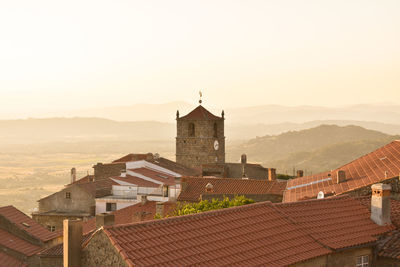 Buildings in city against clear sky