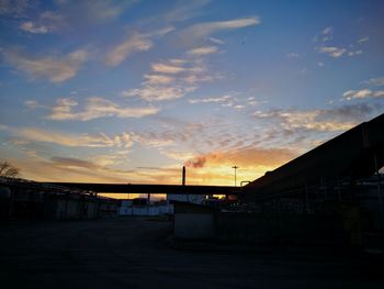 Silhouette city against sky during sunset